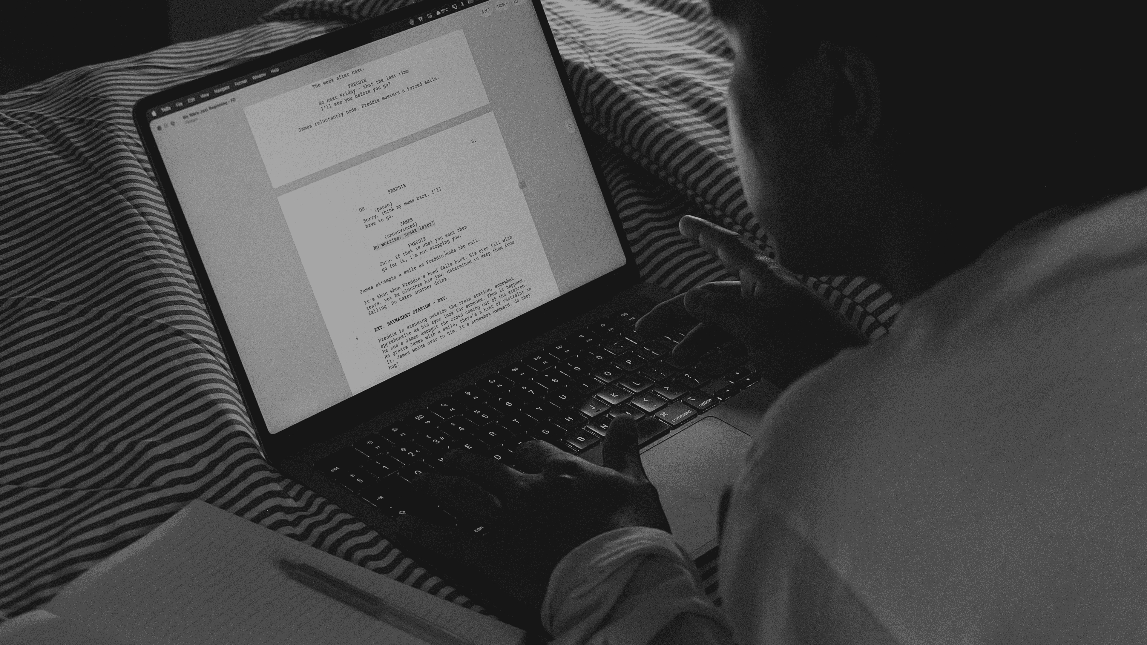 Writer working on a screenplay in Tella from bed